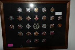 A framed group of largely Fire Brigade badges including Glasgow, Central, Strathclyde, Fife etc (