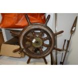 A brass-mounted ship's wheel