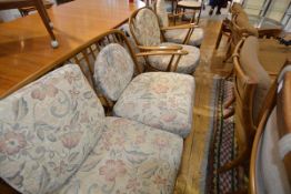 An Ercol beech sitting room suite of two seater sofa and a pair of armchairs