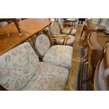 An Ercol beech sitting room suite of two seater sofa and a pair of armchairs