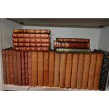 A collection of leather volumes including works by William Makepeace Thackeray and Charles Dickens