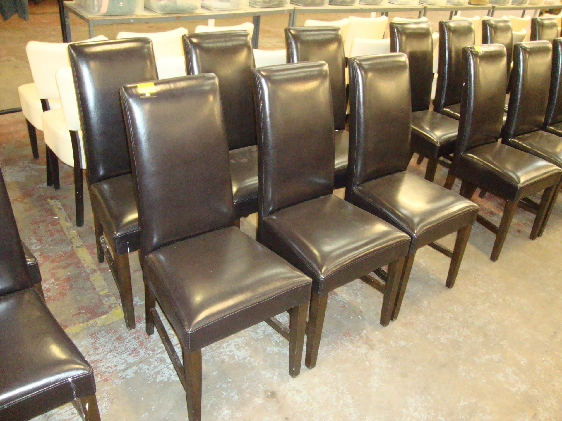 6 off chocolate brown upholstered leather/leather look dining chairs on dark wooden legs. NB lots 41