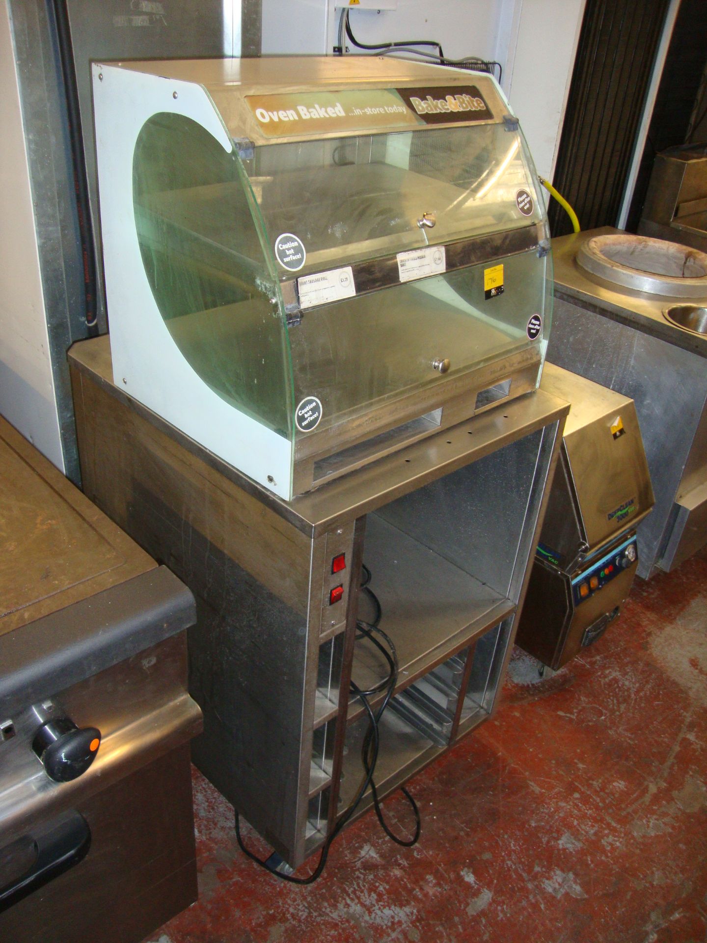 Metal warming trolley with oven baked display unit above