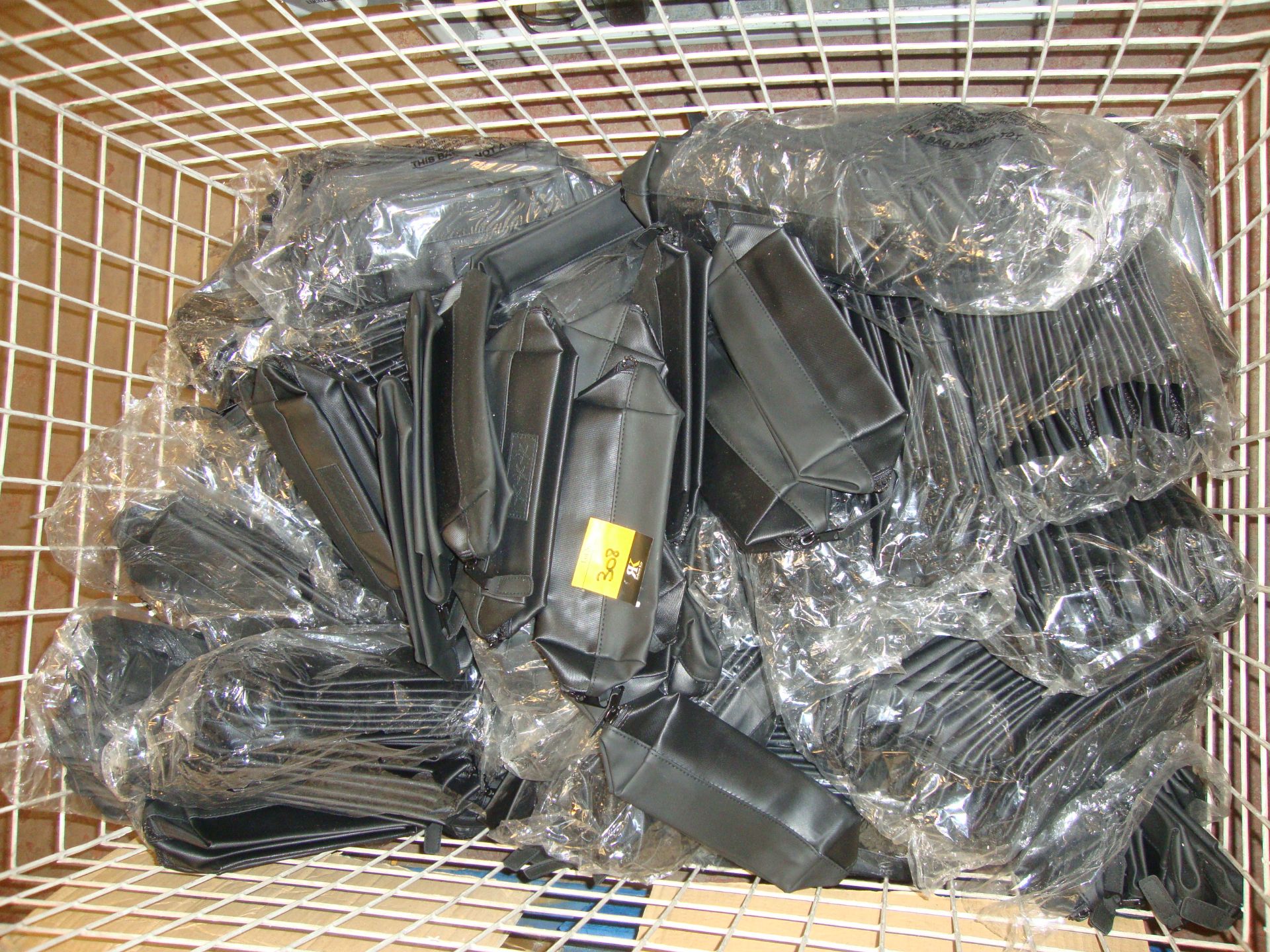 The contents of a cage containing a very large quantity of black zip up cosmetic pouches/toiletry - Bild 2 aus 3