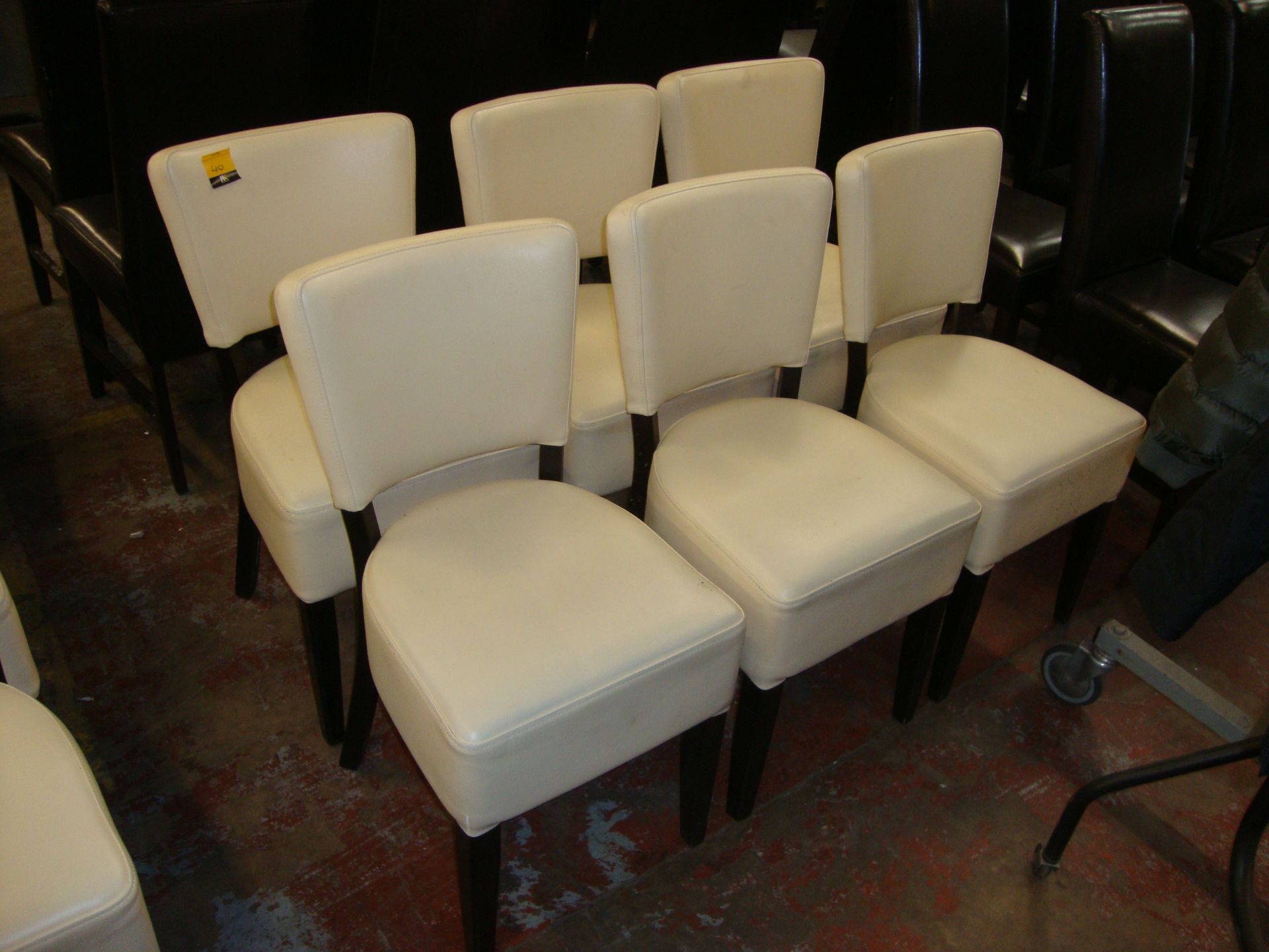 6 off cream upholstered chairs in leather/leather look on dark brown legs. NB lots 35 - 40 each