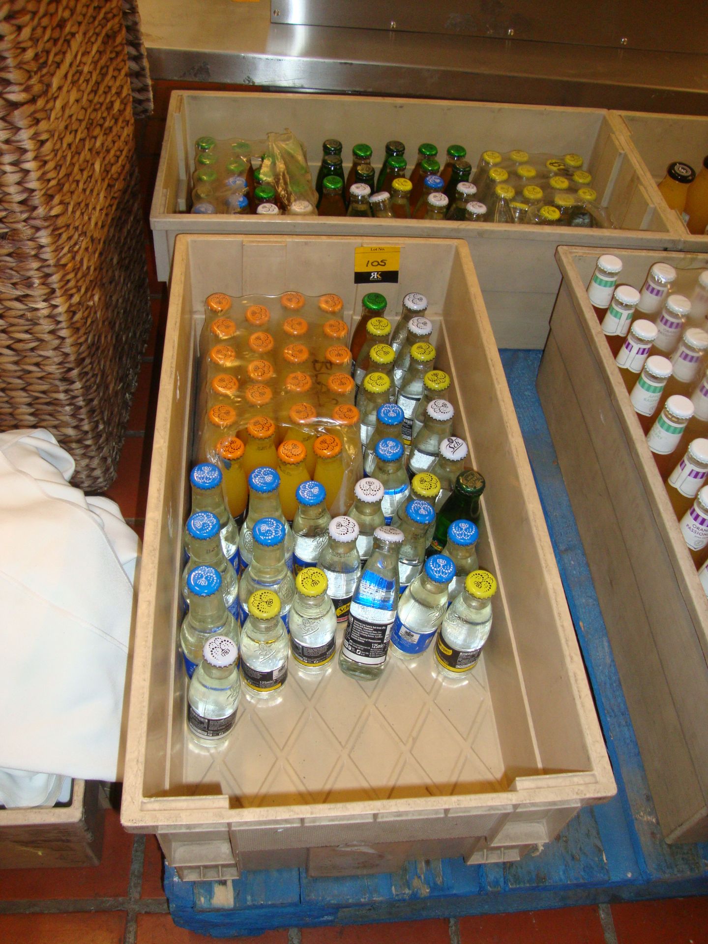 The contents of 2 crates of assorted mixers including tonic water, orange juice, etc