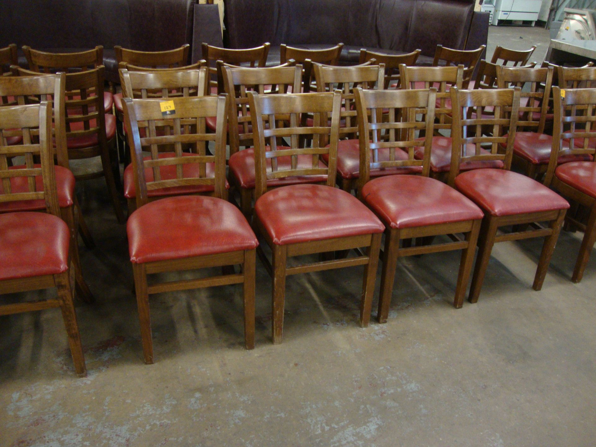 8 off wooden chairs with red upholstered bases. NB lots 121 – 129 consist of different quantities of