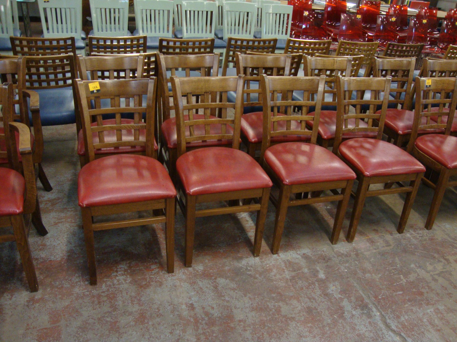 8 off wooden chairs with red upholstered bases. NB lots 121 – 129 consist of different quantities of