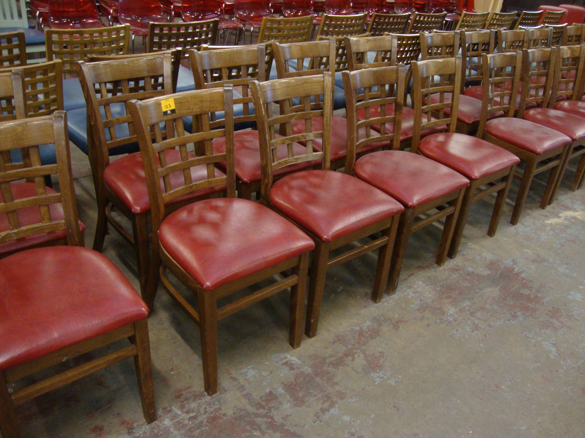 8 off wooden chairs with red upholstered bases. NB lots 121 – 129 consist of different quantities of