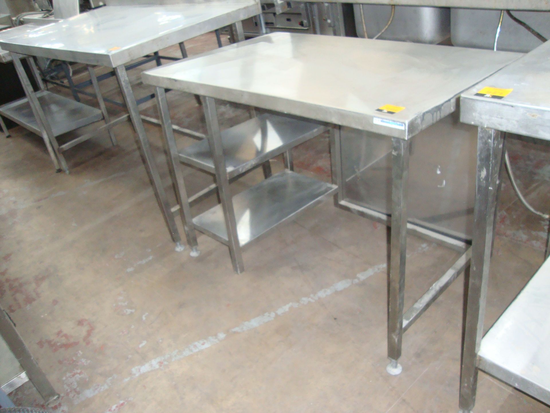 Stainless steel table with a series of narrow shelves below same circa 1100mm x 700mmIMPORTANT: