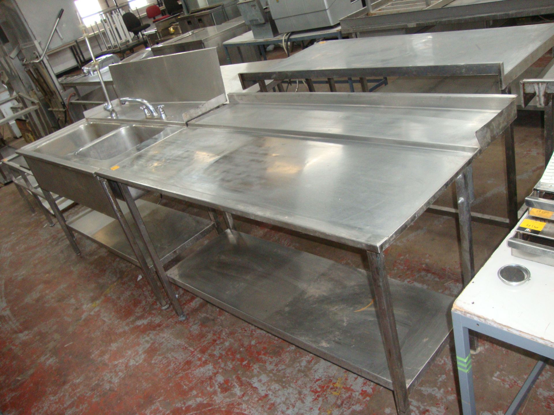 Stainless steel large twin bowl sink arrangement in two sections, the first comprising two large