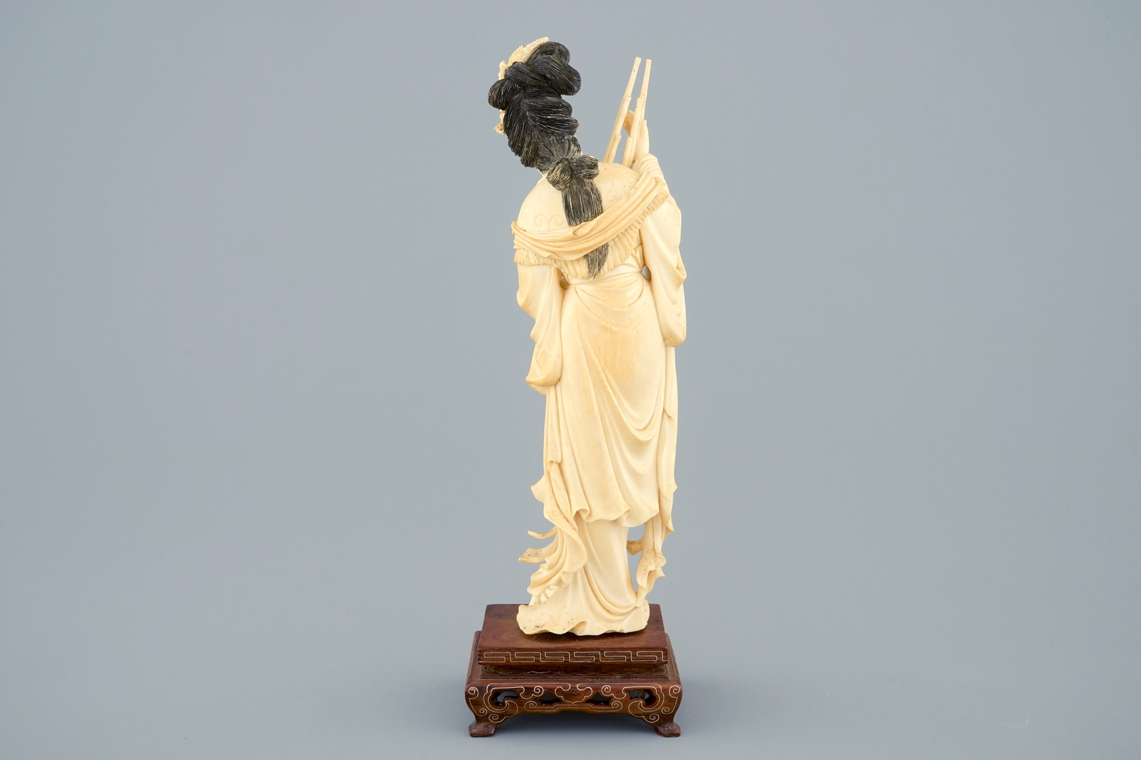 A Chinese carved ivory figure of a lady on wooden base, ca. 1900 - H.: 29,5 cm -