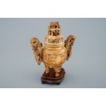 A Chinese carved ivory tripod censer on wooden base, 19th C. - H.: 26 cm -