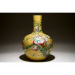A Chinese famille rose tianqiuping bottle vase with 9 peaches design on a dark yellow ground, 19/