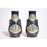 A pair of Chinese famille verte on powder blue and gilt ground vases, 19th C. H.: 30 cm Condition