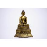 A gilt bronze model of Buddha seated on a throne, Nepal or Tibet, 19/20th C. H.: 26 cm - Dim.: 17