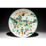 A very large Chinese famille verte dish with ladies and playing boys in a garden, 19th C. Dia.: 46,5