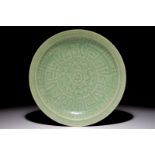 A Chinese celadon dish with incised lotus design, 19th C. Dia.: 27 cm Condition reports and high