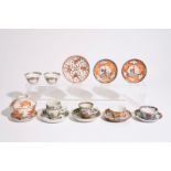 A varied lot of Chinese famille rose and iron red cups and saucers, 18/19th C. Dia.: 12 cm (