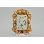 A Chinese gilt filigree silver hat ornament with jade inset, 19/20th C. Dim.: 10 x 7 cm Condition