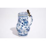 A twisted Chinese blue and white metal-mounted covered jug, Kangxi H.: 17,5 cm Condition reports and