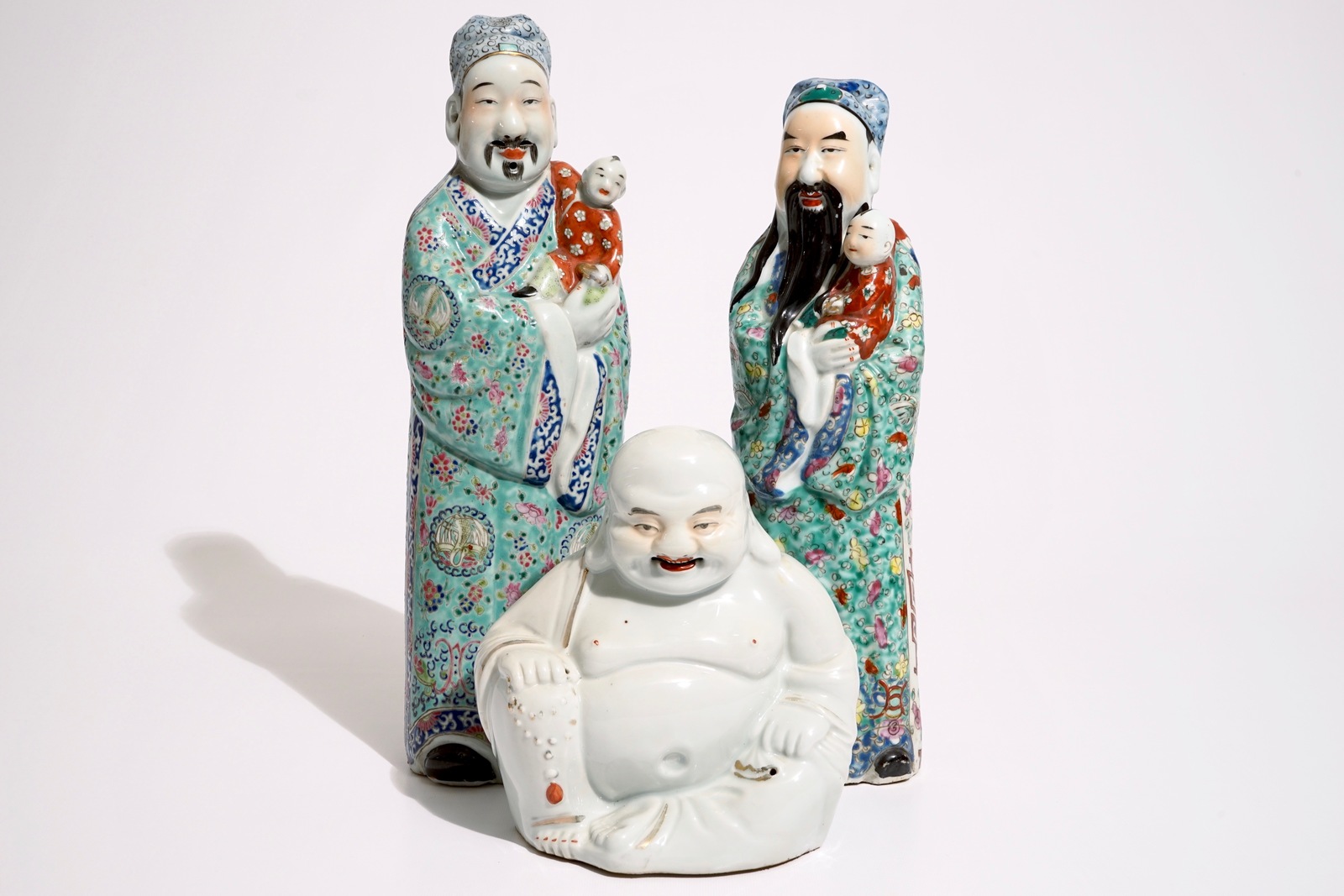 Two Chinese famille rose figures of immortals and a white-glazed model of Buddha, 19/20th C. H.: