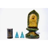 A Chinese sancai Buddha on a throne, two turquoise Guanyin figures and a black and gilt brushpot,