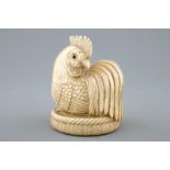 A Japanese ivory netsuke in the shape of a rooster, signed on the base, 19th C. H.: 7,5 cm