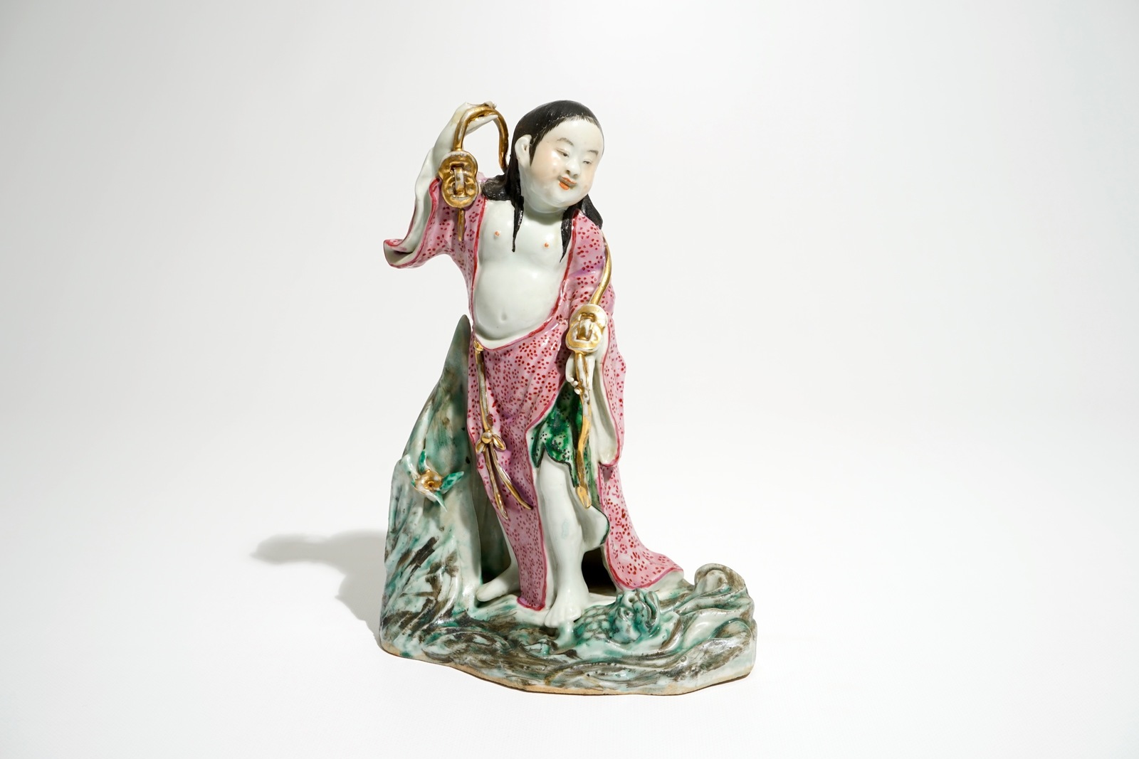 A Chinese famille rose figure of Liu Hai with the toad, 20th C. H.: 25,5 cm Condition reports and