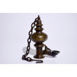 A bronze oil lamp, Tibet, 19/20th C. Dim.: 43,5 (h) x 11 x 7 cm (including the total length of the