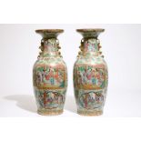 A pair of Chinese Canton famille rose on celadon ground vases, 19th C. H.: 60,5 cm Condition reports