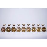 Nine Chinese famille rose on capucin brown ground cups and saucers, Qianlong Dia.: 10,5 cm (the