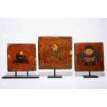 A set of three lacquered and painted tiles, Tibet or Nepal, 19/20th C. Dim.: 28,5 x 27,5 cm - H.: 35