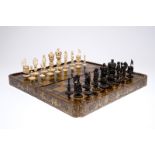 A fine Chinese lacquer chess and backgammon board with ivory game pieces, 19th C. Dim.: 49,5 x 49,