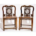 A pair of Chinese carved hardwood chairs with marble inset, 19/20th C. H.: 89 cm - L.: 52 cm - W.: