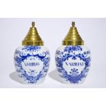 A pair of Dutch Delft blue and white tobacco jars with brass covers, 19th C. H.: 31 cm (incl. cover)
