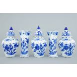 A tall blue and white Dutch Delft five-piece garniture with parrots among foliage, 18th C. H.: 38 cm
