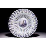 A Dutch Delft blue and manganese lobed dish with a boat, 17/18th C. Dia.: 33 cm Condition reports