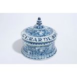 A Dutch Delft blue and white tobacco box and cover with tamper, dated 1763 H.: 15 cm The cover