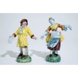 A pair of polychrome figures of newspaper sellers in Dutch Delft style, North of France, 19th C. H.: