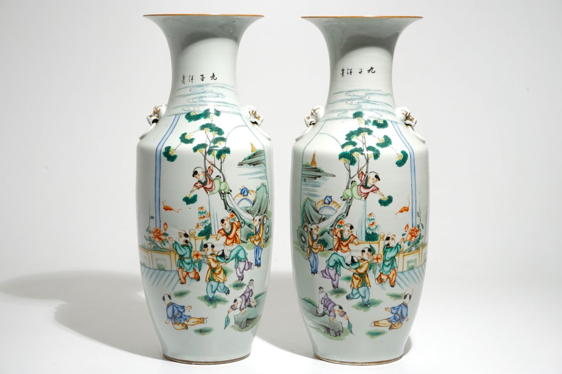 A pair of Chinese famille rose vases with playing boys, 19/20th C.