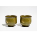 A pair of Chinese teadust-glazed and gilt wine cups with bats, Qianlong mark, 20th C.