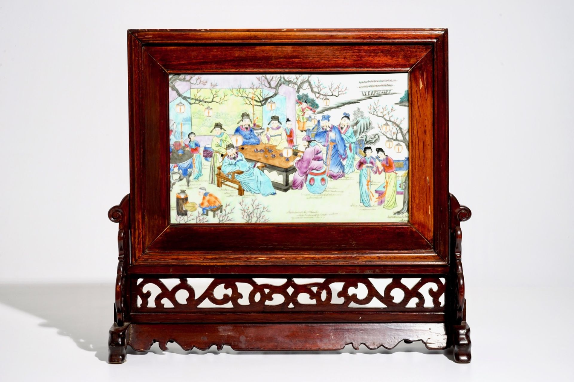 A Chinese wooden table screen with a famille rose plaque, 20th C.