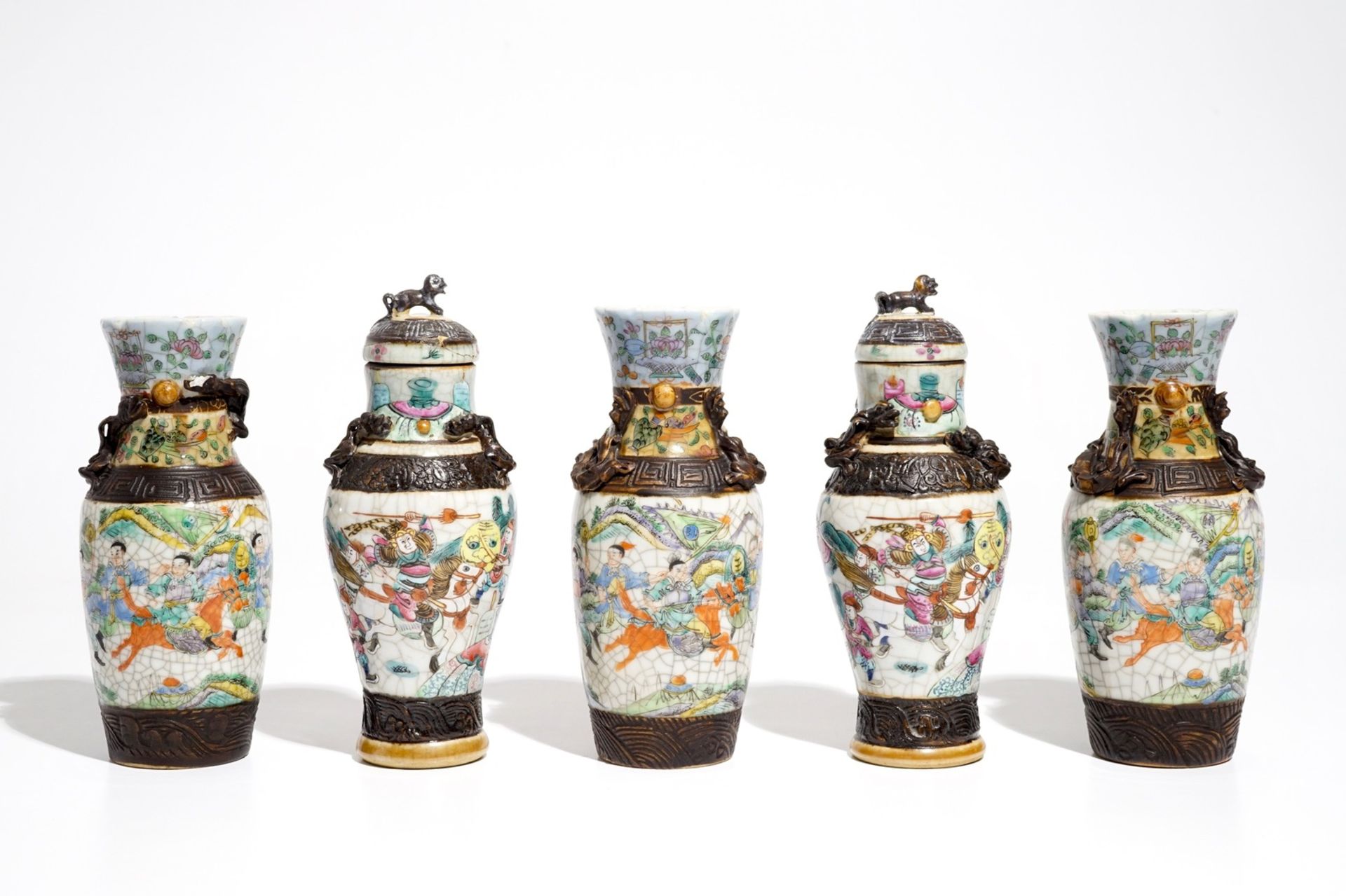 Two Chinese Nanking famille rose covered vases and three Nanking famille verte vases, 19th C.