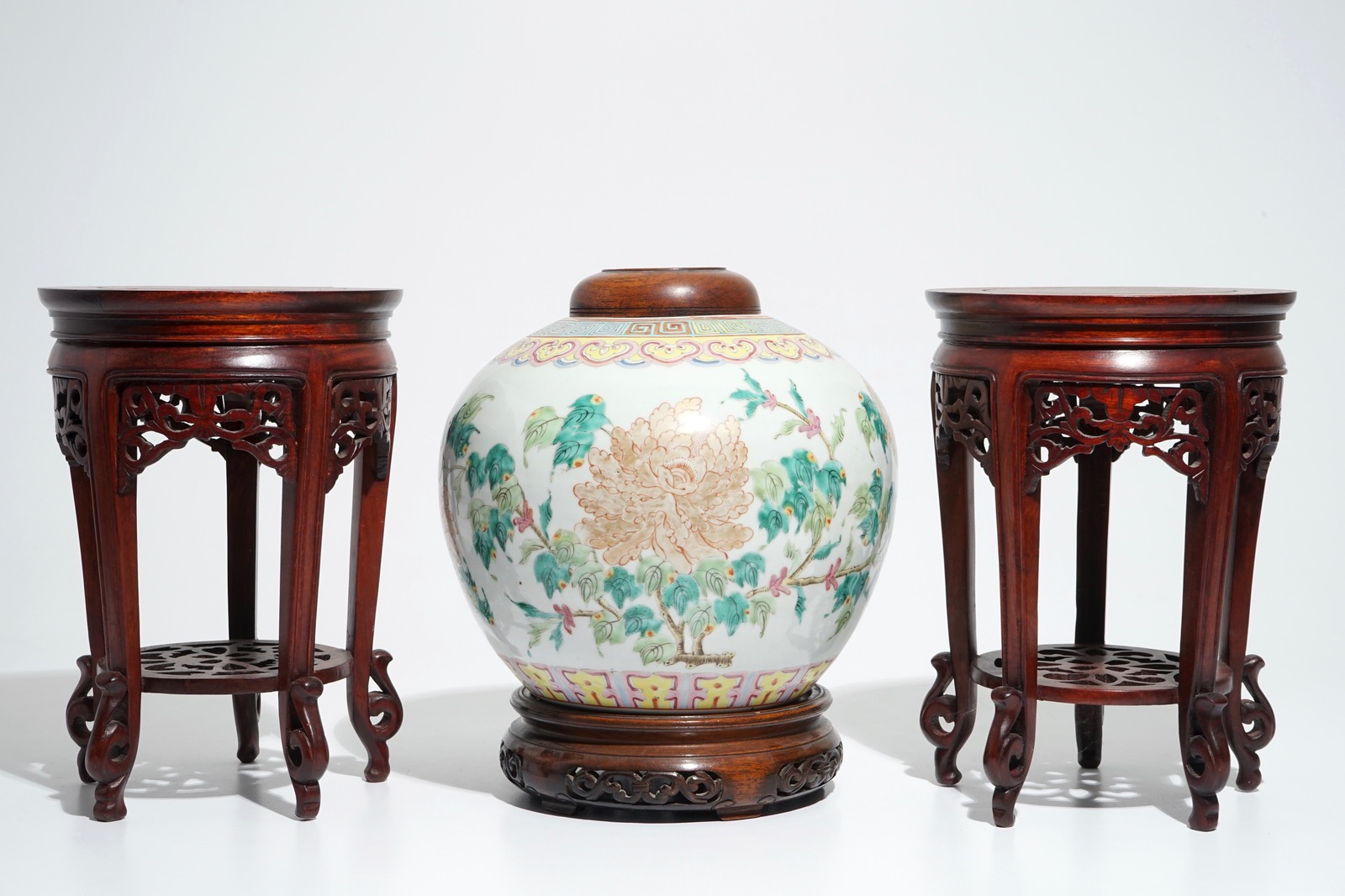 A Chinese famille rose jar and cover, with a pair of wooden stands, 19/20th C.