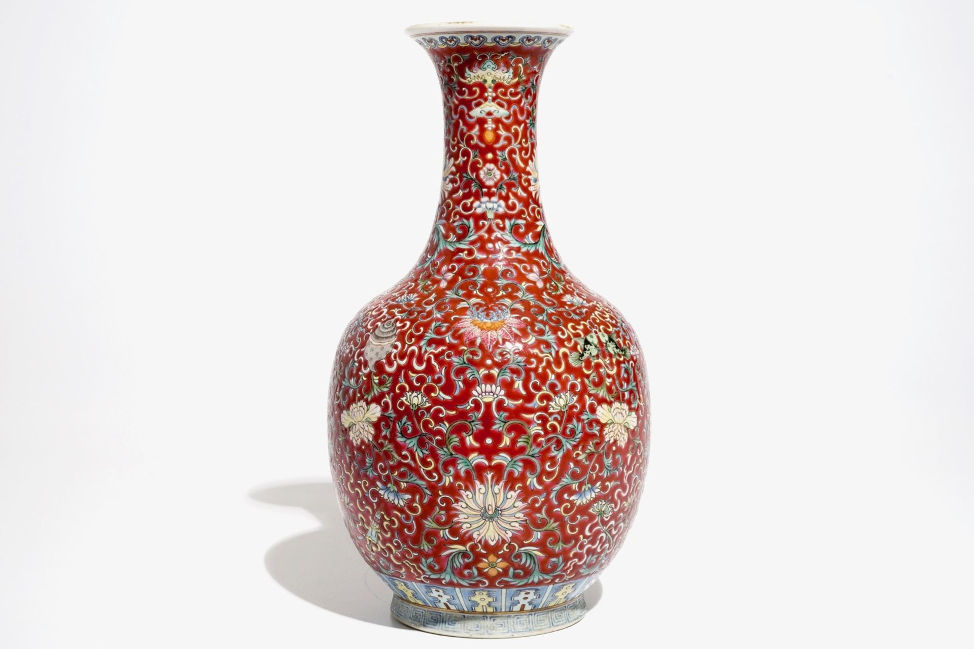 A Chinese red-ground famille rose bottle vase, Qianlong mark, 19/20th C. - Image 3 of 7