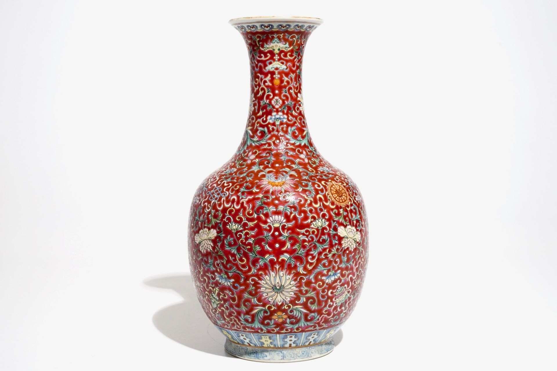 A Chinese red-ground famille rose bottle vase, Qianlong mark, 19/20th C. - Image 5 of 7