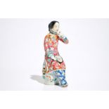 A Chinese famille rose model of a lady on a garden seat, 19th C.