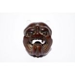 A Japanese carved boxwood netsuke of a devil's or demon's head, Edo/Meiji, 18/19th C.