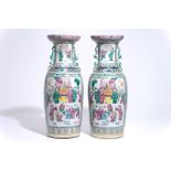 A pair of tall Chinese famille rose vases with figural design, 19th C.